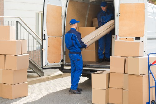 Removal van and moving boxes in a Mitcham residential street