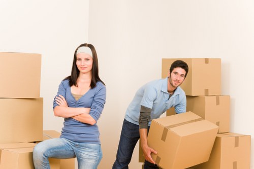 Removal team carrying household items through a residential property