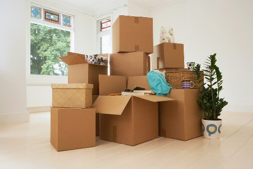 Professional movers carrying furniture down stairs